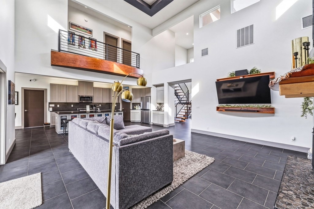 Modern open-concept living room and kitchen with wood accents in a Grape Creek, TX home