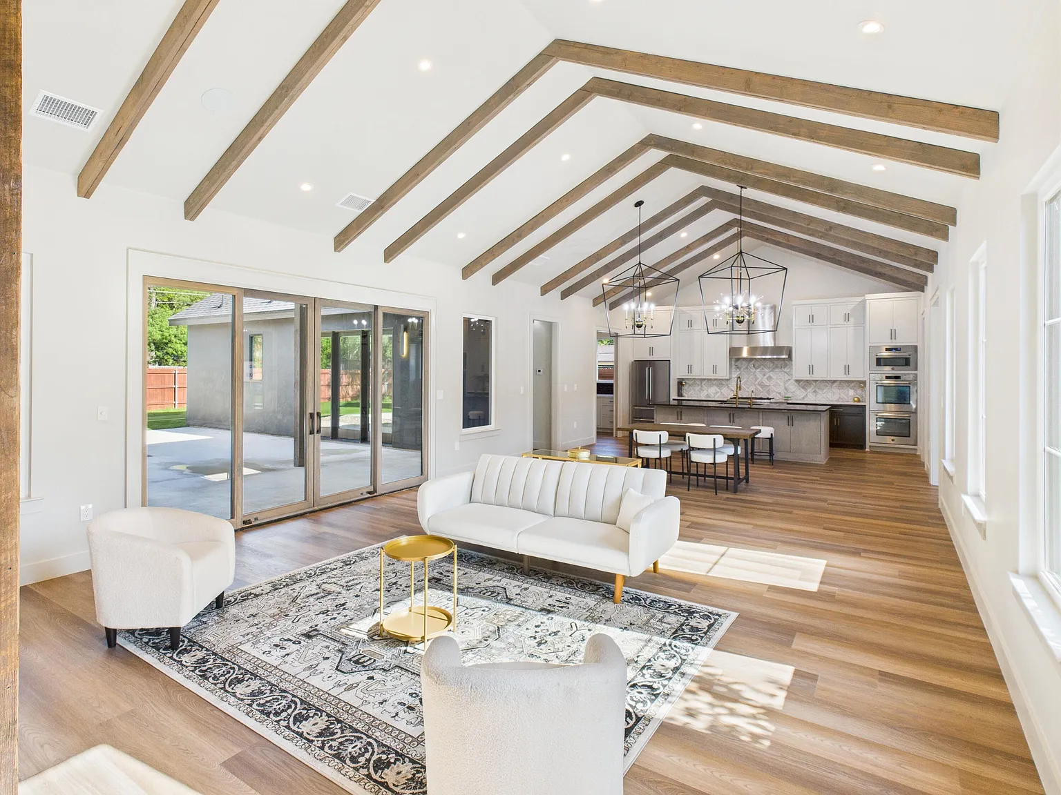Bright open-concept San Angelo, TX home interior with vaulted wood-beam ceilings