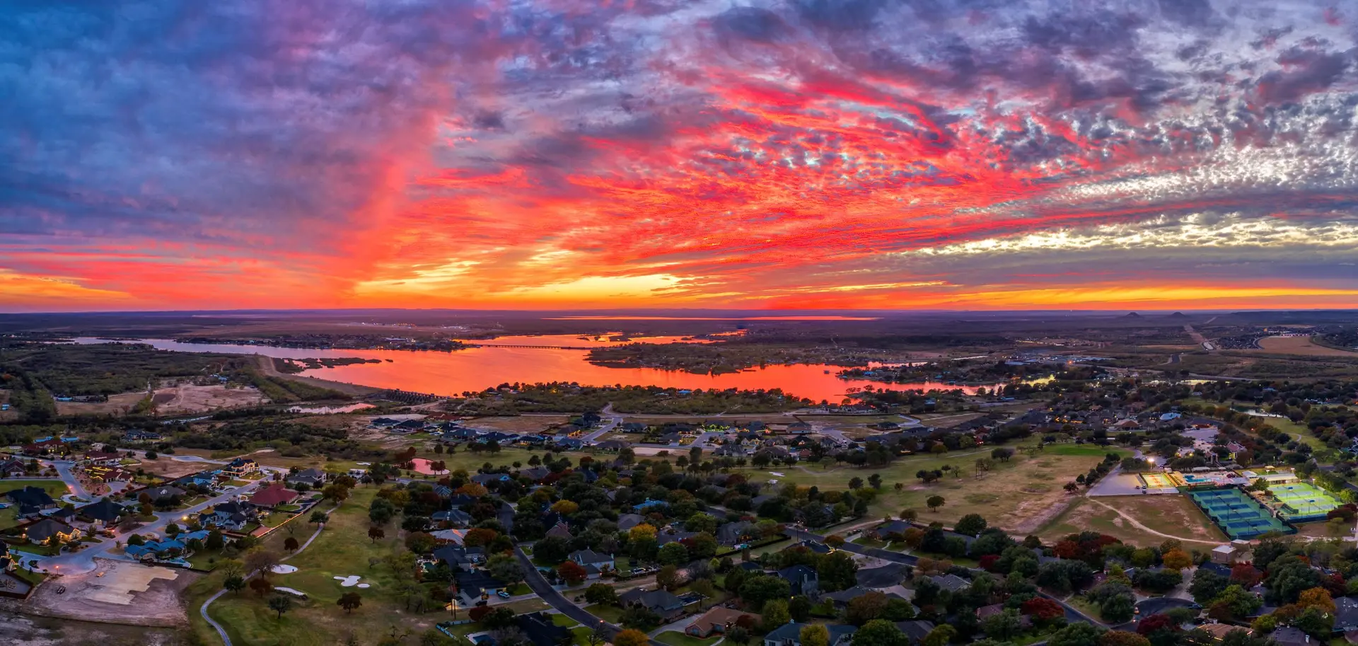 Sunset over a San Angelo, TX neighborhood with Lake Nasworthy in the foreground